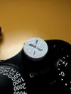 Shutter button with "X" logo