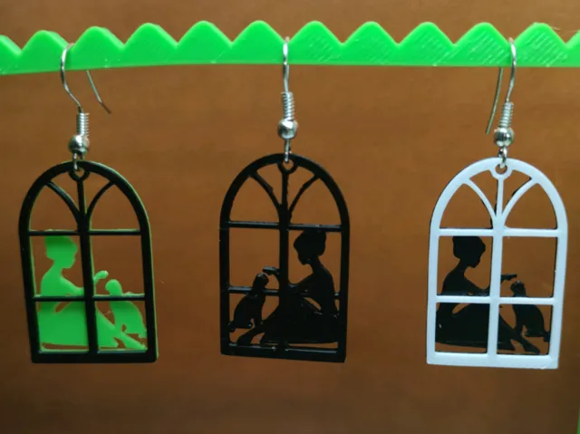 woman with a cat in the window - earrings