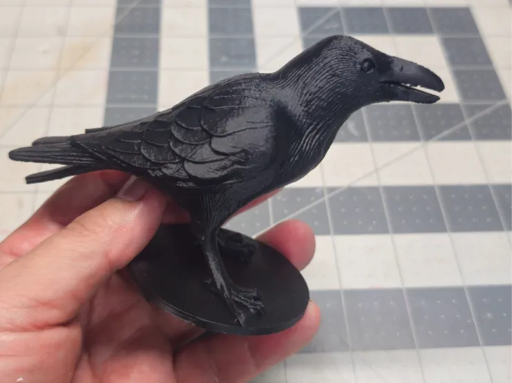 small crow on base