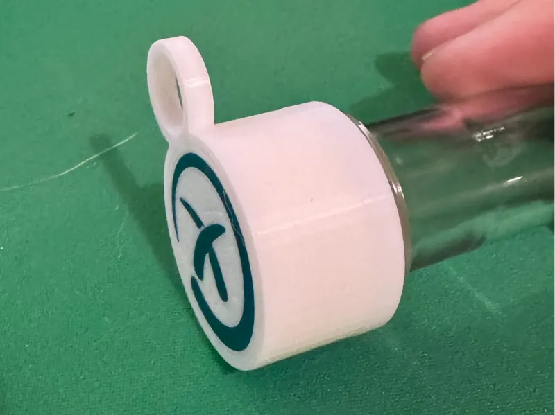 Preform cap with geocaching logo and loop
