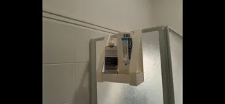 Shower glass panel hanging shelf