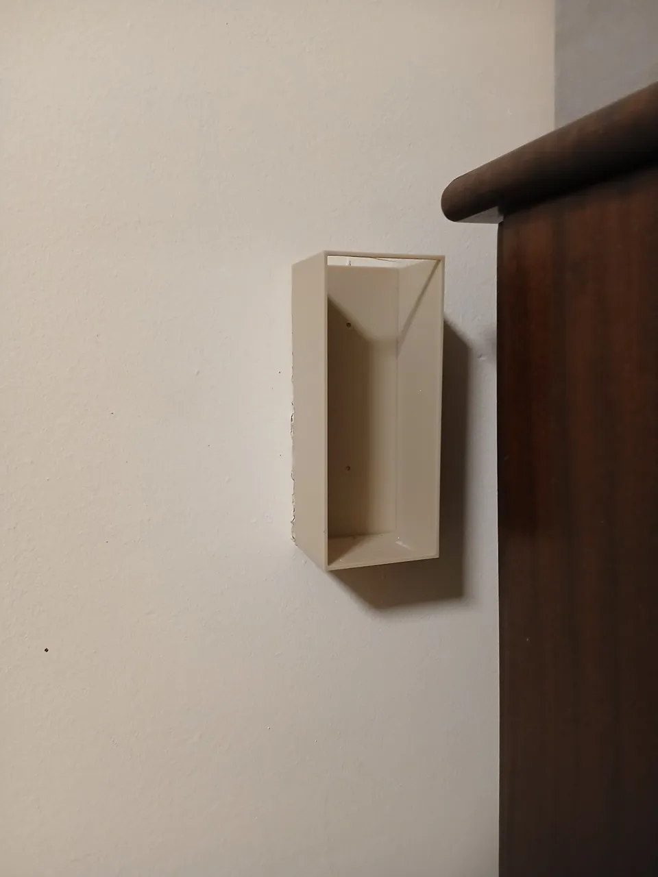 Wall-mounted extension cord holder view 2