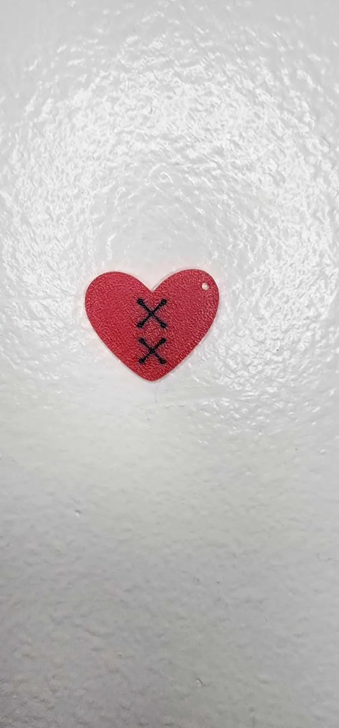 Heart with stitches earrings view 2