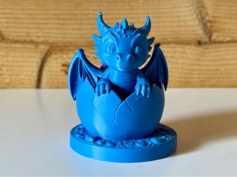 Cute little dragon in cracked egg