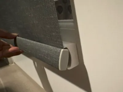 Door bottom anchor for roller shades