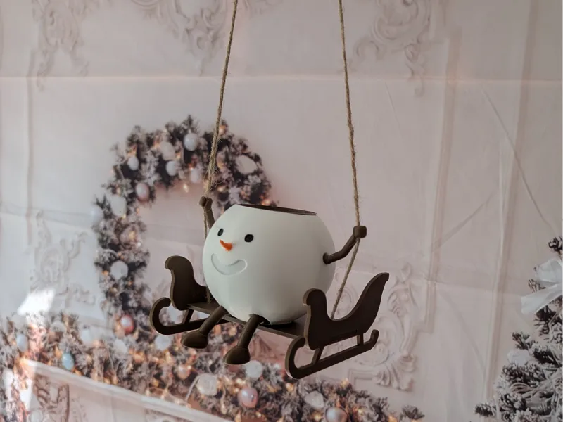 Snowman planter on sleigh swing