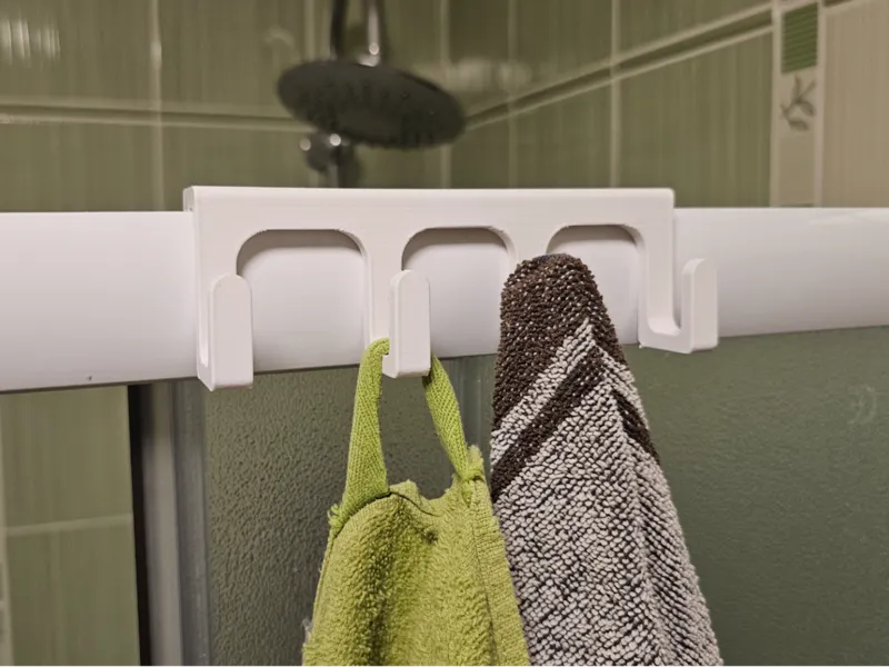 Hanging towel rack for the shower wall