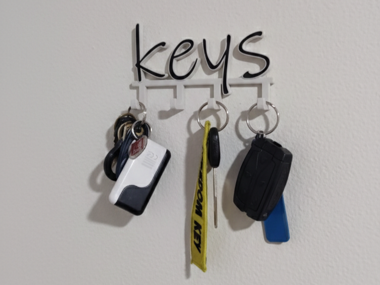 Simple minimalistic key holder that spells Keys