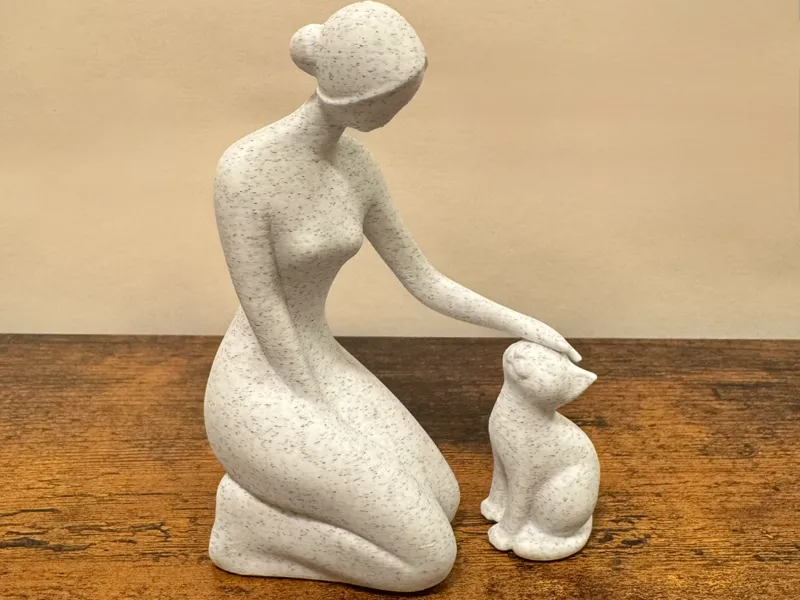 Gentle Moments: Woman Petting Cat Sculpture