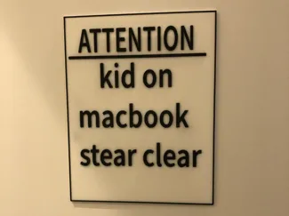 kid on MacBook sign with ams