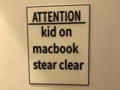 kid on MacBook sign with ams