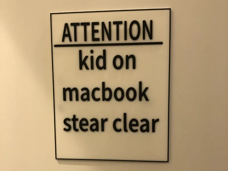 kid on MacBook sign with ams