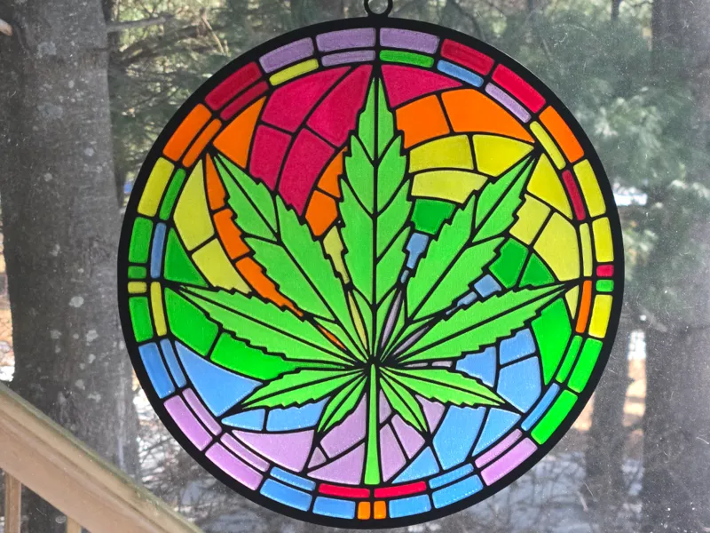 Stained glass leaf on rainbow background