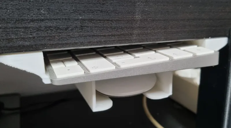 iMac keyboard and mouse under desk