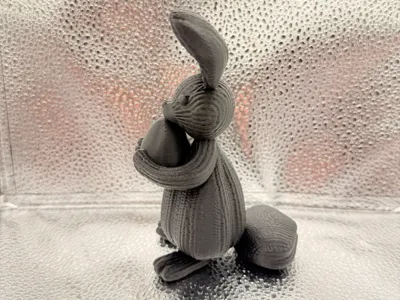 Easter bunny with egg in a knitted pattern