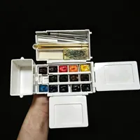 Place a portable watercolor pen and a mini pencil