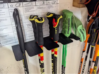 Wall-mounted ski pole holder