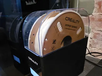 Cardboard spool protector for dryers/ams
