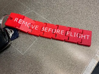 Hinged Flexi Remove Before Flight Keychain Tag