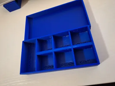 Weekly pill organizer with embossed days
