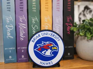 Briar U Hawks Puck (Off Campus series) with stand