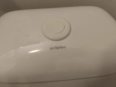 Sphinx toilet flushing button