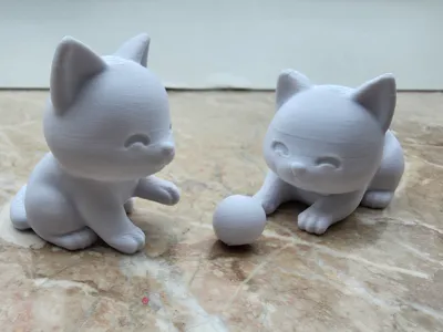 2 Cute Cats playing with a ball