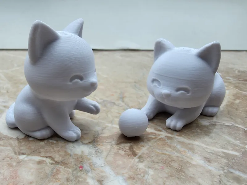 2 Cute Cats playing with a ball