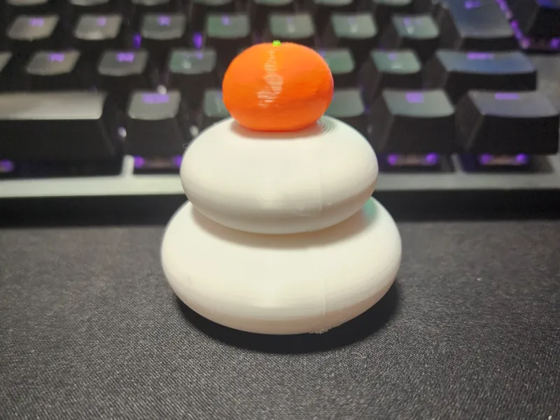 stacked rice cakes with an orange on top japan