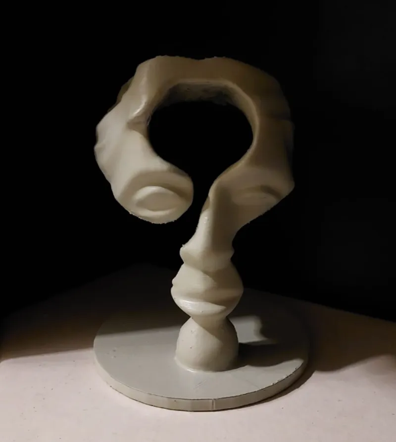 Question mark sculpture with facial features