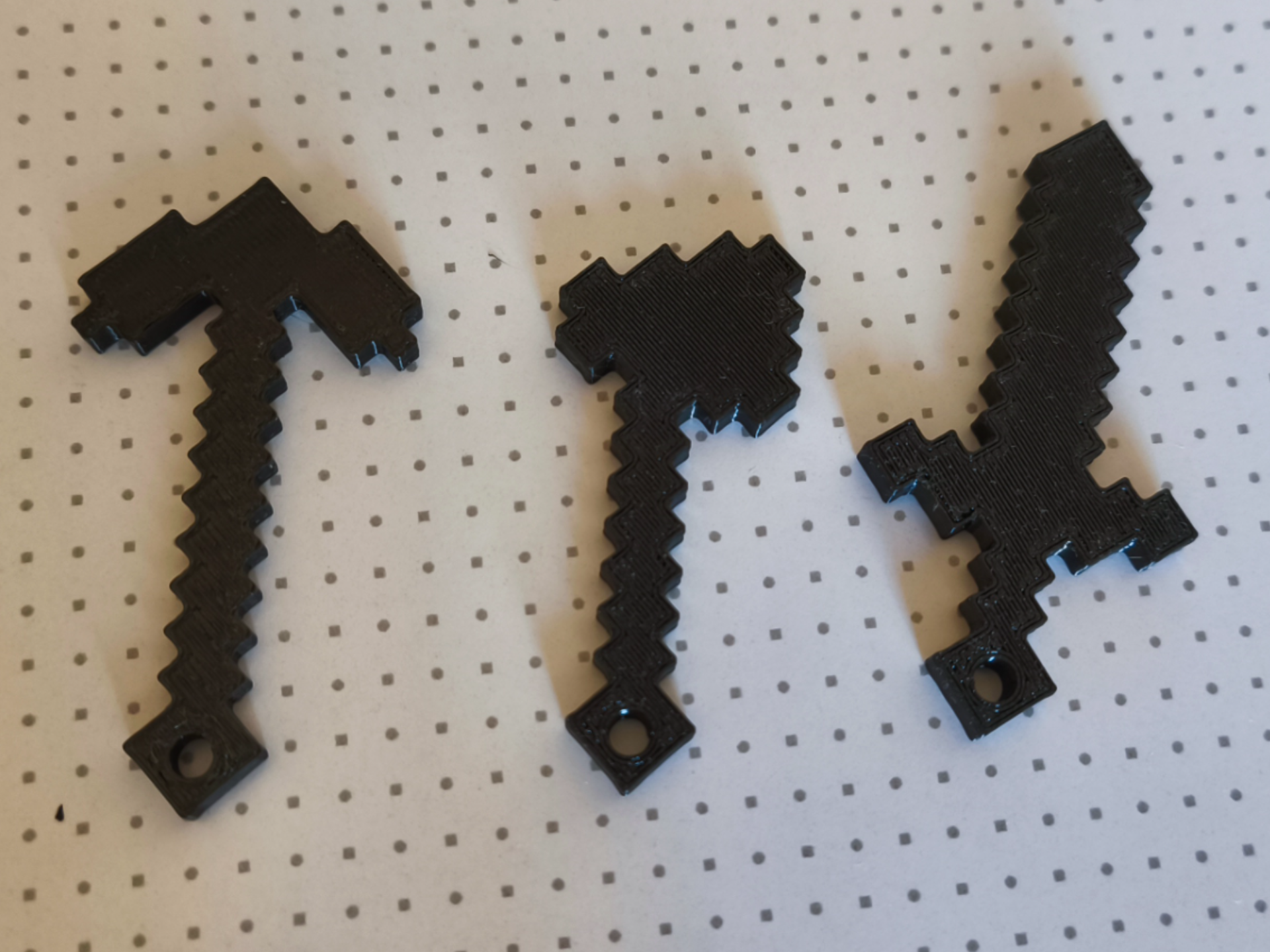 Minecraft keychain with a sword, pickaxe, and axe