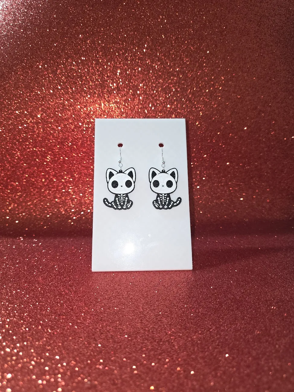 Cat skeleton earrings view 2