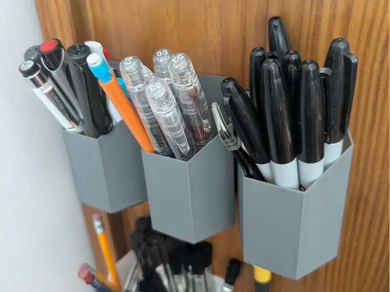 Wall mounted hexagonal pen holder
