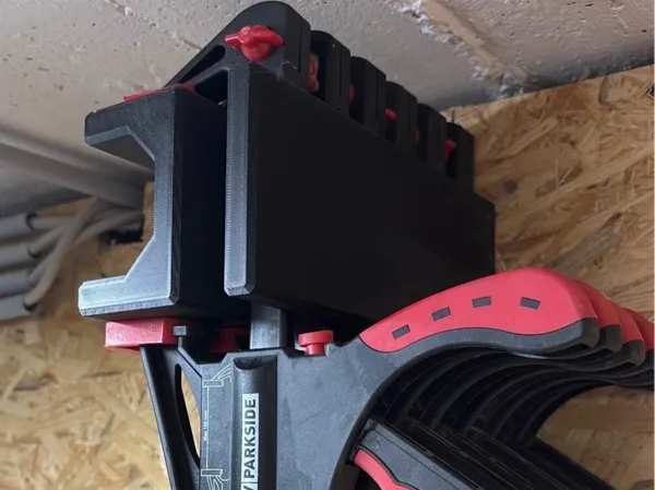 Support mural pour serre-joints à une main