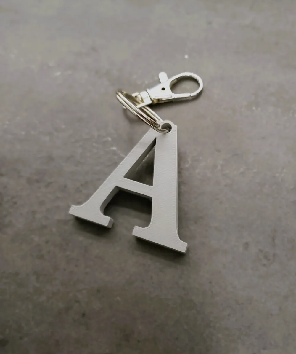 Portachiavi Metallico Lettera E | Meta[l]morphose, 3D A Forma Di Palloncino, Glitter Oro, In Acciaio Inox