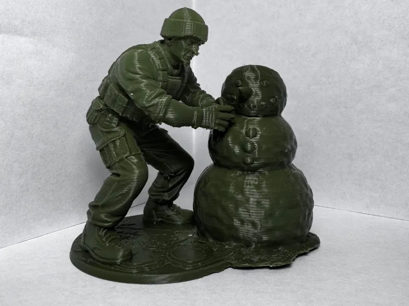 Green Army Man building a Snowman