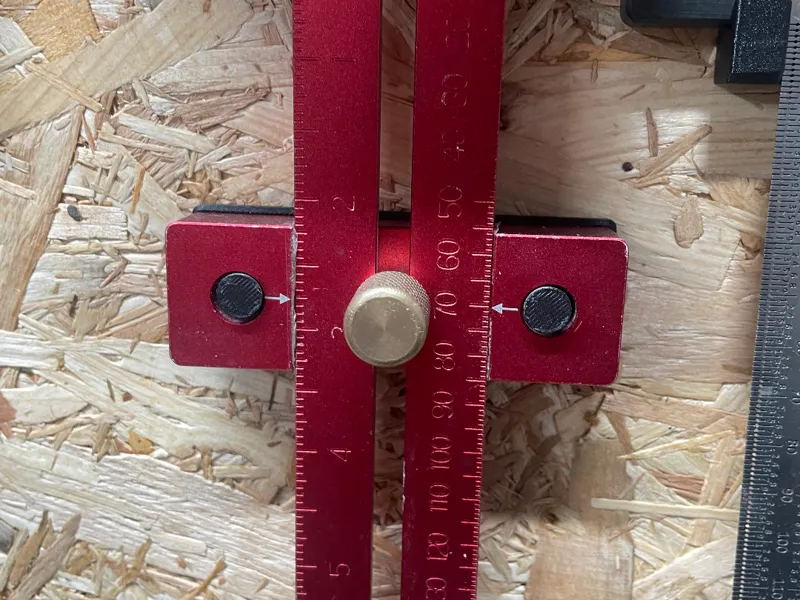 A simple wall mounted holder for a sliding ruler