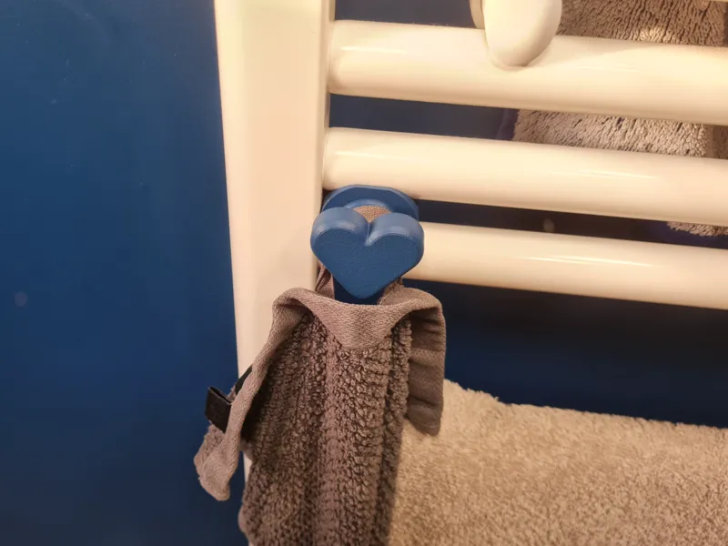 Heart shaped towel hanger for towel radiator