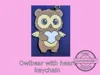 Owlbear holding a heart keychain