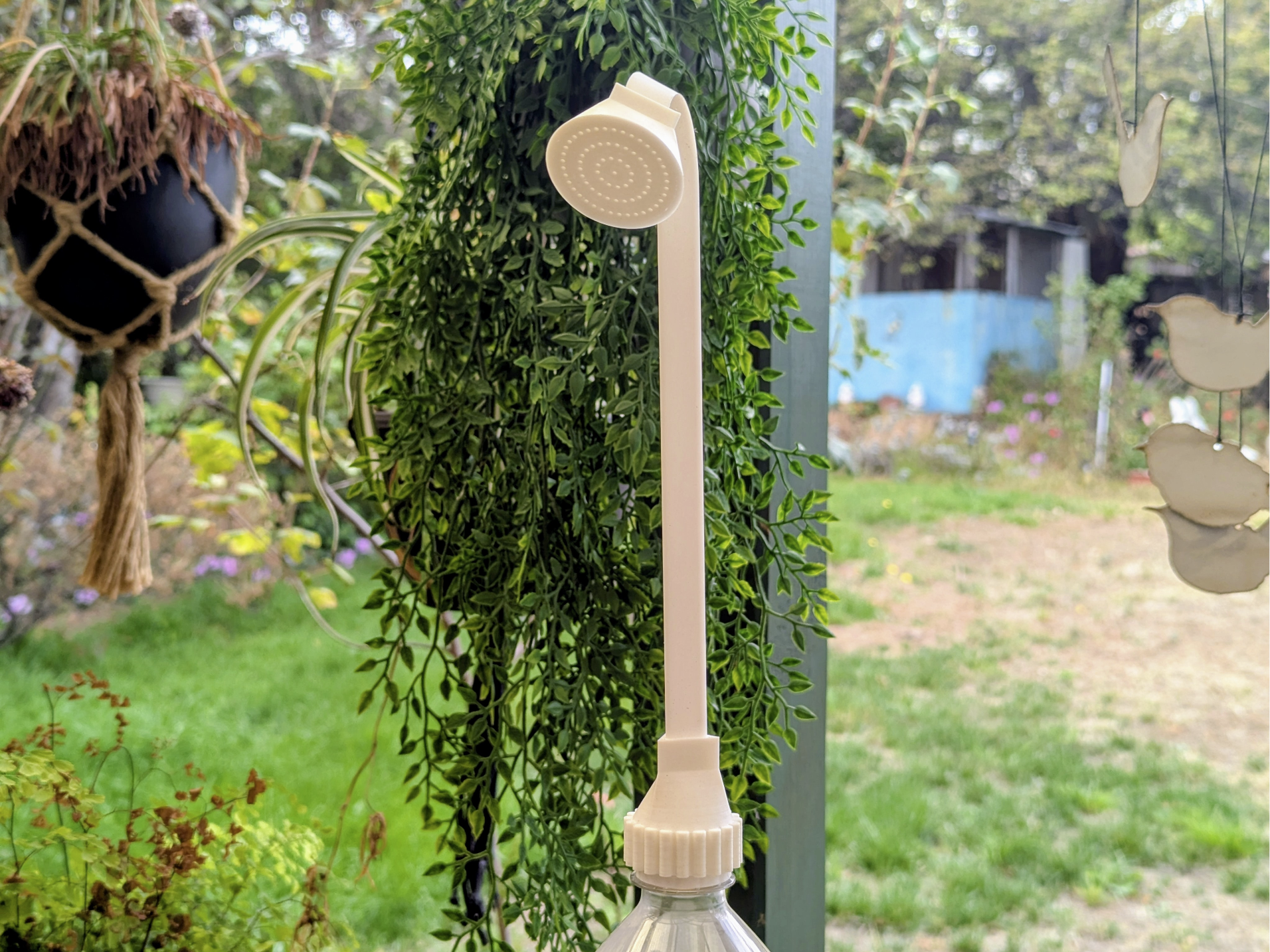 Soda bottle watering can for hanging pot planters
