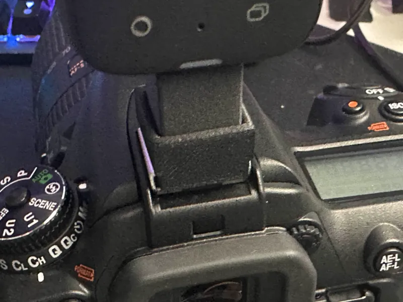 Nikon Cold Shoe to 1/4"-20 screw adapter.
