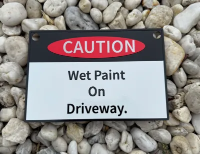 Caution Sign Wet Paint on Driveway. 