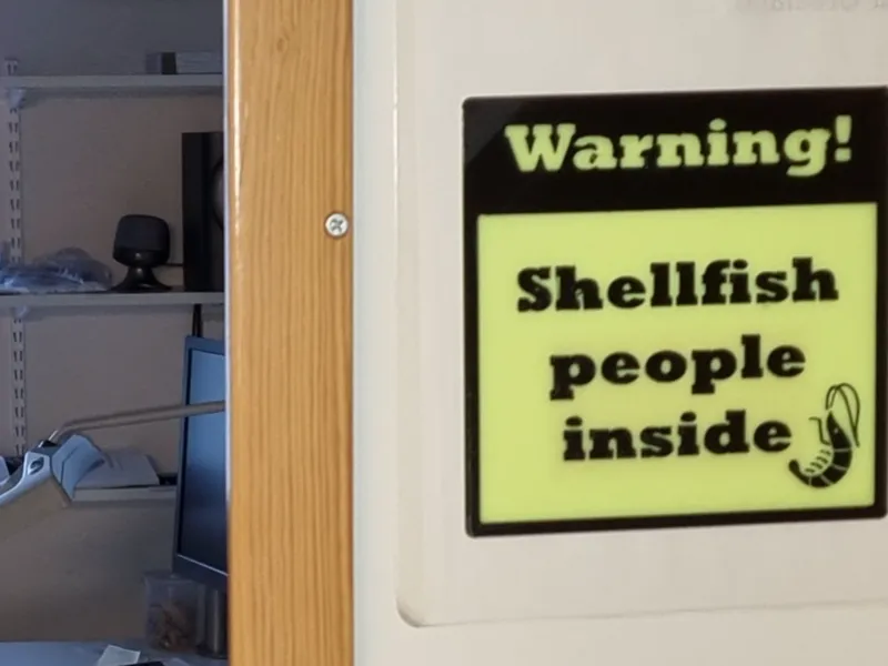 Warning sign: Warning! - Shellfish people inside