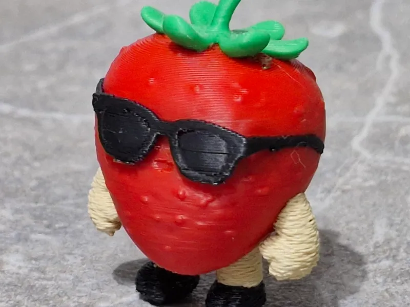 Strawberry character figurine with sunglasses