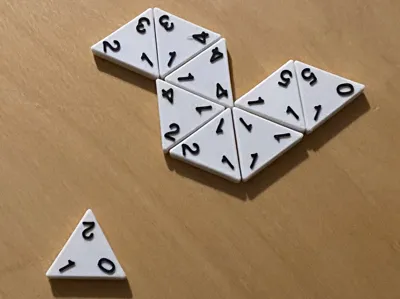 Triominos: A Domino Variant Employing Triangular Tiles
