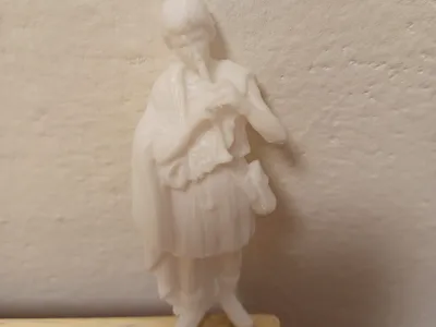 Nativity figurine (boy with flute)