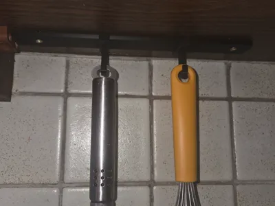 sliding under cabinet hook for rail system