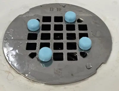 Shower drain plate spacer