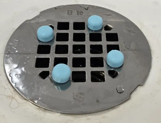 Shower drain plate spacer