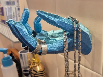 Wall-mounted jewelry holder in the shape of a hand